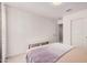 Bright bedroom with a neutral color palette, closet, and a minimalist bench at 14253 W El Cortez Pl, Surprise, AZ 85387