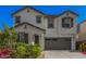 Charming two-story home featuring a well-manicured front yard and a two-car garage at 14253 W El Cortez Pl, Surprise, AZ 85387