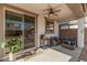 Comfortable covered patio with ceiling fan and outdoor seating arrangement at 14253 W El Cortez Pl, Surprise, AZ 85387