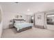 Spacious main bedroom featuring plush carpet, plenty of natural light, and calming decor at 14253 W El Cortez Pl, Surprise, AZ 85387