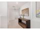 Modern hallway featuring wood console table, and neutral colored artwork at 14253 W El Cortez Pl, Surprise, AZ 85387