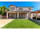 Home's backyard features playground, covered patio, and lush artificial grass at 14604 W Banff Ln, Surprise, AZ 85379