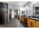 Bathroom with double sinks, granite counters, walk-in shower with tile surround at 14604 W Banff Ln, Surprise, AZ 85379