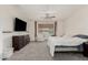 Bright bedroom boasts neutral walls, gray carpet, and a large window for natural light at 14604 W Banff Ln, Surprise, AZ 85379