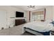 Carpeted bedroom with plenty of open space, a ceiling fan, and a large window at 14604 W Banff Ln, Surprise, AZ 85379