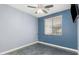 A bedroom features a ceiling fan and a window at 14604 W Banff Ln, Surprise, AZ 85379