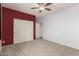 Spacious bedroom featuring a ceiling fan, neutral-colored walls and carpet flooring at 14604 W Banff Ln, Surprise, AZ 85379