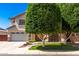 Charming two-story home boasts a landscaped yard and attached two-car garage at 14604 W Banff Ln, Surprise, AZ 85379
