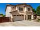 Two-story stucco home with stone accents, attached garage and large driveway at 14604 W Banff Ln, Surprise, AZ 85379