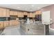 Modern kitchen features stainless steel appliances, wooden cabinets, and an island at 14604 W Banff Ln, Surprise, AZ 85379