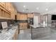 Spacious kitchen with granite countertops, wood cabinets, and modern appliances at 14604 W Banff Ln, Surprise, AZ 85379