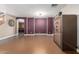 Spacious living room with hardwood floors, staircase, door, and neutral paint at 14604 W Banff Ln, Surprise, AZ 85379