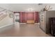 Spacious room showcasing neutral walls, a built-in cabinet, and an adjoining living area at 14604 W Banff Ln, Surprise, AZ 85379