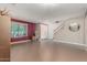 Open-concept living room with neutral paint, staircase and large front window at 14604 W Banff Ln, Surprise, AZ 85379