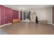 Spacious room showcasing neutral walls, a built-in cabinet, and an adjoining living area at 14604 W Banff Ln, Surprise, AZ 85379