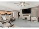 View of living room flowing into the kitchen with a modern ceiling fan at 14604 W Banff Ln, Surprise, AZ 85379
