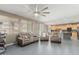 Open-concept living room and kitchen featuring modern ceiling fan and sliding glass door at 14604 W Banff Ln, Surprise, AZ 85379