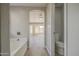 Bright primary bathroom with a tub, toilet, and lots of light at 15067 W Taylor St, Goodyear, AZ 85338