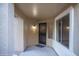 Covered front entrance features a security gate, modern lighting, and a secure front door at 15067 W Taylor St, Goodyear, AZ 85338
