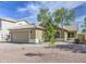 Inviting single-Gathering home featuring a neutral color palette, desert landscaping, and an attached two car garage at 15067 W Taylor St, Goodyear, AZ 85338