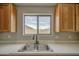 Close-up on the kitchen sink, granite countertops, and light wood cabinets at 15067 W Taylor St, Goodyear, AZ 85338