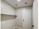 Functional laundry room with modern amenities, including a utility sink, and storage space at 15067 W Taylor St, Goodyear, AZ 85338