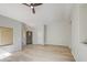 Spacious living room with a vaulted ceiling, wood-look floors, and modern ceiling fan at 15067 W Taylor St, Goodyear, AZ 85338