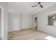 Spacious living room with a vaulted ceiling, wood-look floors, and modern ceiling fan at 15067 W Taylor St, Goodyear, AZ 85338