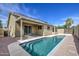 Inviting backyard pool with clear water, concrete surround and tanning ledge, surrounded by desert landscaping at 15067 W Taylor St, Goodyear, AZ 85338