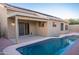 Backyard pool featuring desert landscaping, a covered patio, and clear blue water at 15067 W Taylor St, Goodyear, AZ 85338