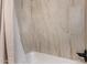 Bathroom tub and shower featuring neutral tile and dark fixtures at 16336 E Palisades Blvd # 4, Fountain Hills, AZ 85268