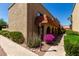 Charming building exterior with beautiful landscaping, sidewalk and colorful flowers at 16336 E Palisades Blvd # 4, Fountain Hills, AZ 85268