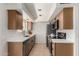 Galley kitchen features sleek countertops, stainless appliances, wood cabinets and tile flooring at 16336 E Palisades Blvd # 4, Fountain Hills, AZ 85268