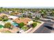 An aerial view of a single-Gathering home with a backyard swimming pool, putting green, and desert landscaping at 1704 E Hackamore St, Mesa, AZ 85203