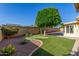 Green backyard with artificial turf, mini golf putting green and desert landscaping at 1704 E Hackamore St, Mesa, AZ 85203