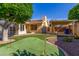 Green backyard with artificial turf, mini golf putting green and desert landscaping at 1704 E Hackamore St, Mesa, AZ 85203