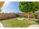 Green backyard with artificial turf, mini golf putting green and desert landscaping at 1704 E Hackamore St, Mesa, AZ 85203