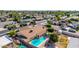 Aerial view of backyard with refreshing swimming pool and mature trees in a well-established neighborhood at 1704 E Hackamore St, Mesa, AZ 85203