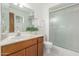 Bright bathroom with updated vanity, sink, and a glass-enclosed shower at 1704 E Hackamore St, Mesa, AZ 85203