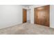 Comfortable bedroom boasts closet space with a neutral color palette at 1704 E Hackamore St, Mesa, AZ 85203