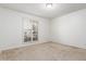 Comfortable bedroom with carpet, a window with shutters, and a ceiling light fixture at 1704 E Hackamore St, Mesa, AZ 85203