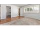 Cozy bedroom with hardwood floors, neutral carpet, shutters, and access to walk-in closet at 1704 E Hackamore St, Mesa, AZ 85203