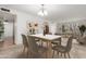 Spacious dining room area with modern chandelier, table with seating for six and bright natural light at 1704 E Hackamore St, Mesa, AZ 85203