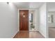 Warm and inviting foyer featuring hardwood floors, stylish front door, and plenty of natural light at 1704 E Hackamore St, Mesa, AZ 85203