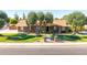 Charming brick front exterior with mature trees and well-maintained landscaping at 1704 E Hackamore St, Mesa, AZ 85203