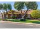 Beautiful brick home with mature trees, green lawn, and well-maintained landscaping at 1704 E Hackamore St, Mesa, AZ 85203