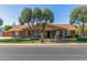 Inviting single-story brick home with mature trees, manicured lawn, and charming walkway at 1704 E Hackamore St, Mesa, AZ 85203