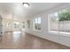 Bright sunroom featuring tiled floors, multiple windows, and access to the backyard at 1704 E Hackamore St, Mesa, AZ 85203