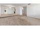 Spacious carpeted living room offering an open floor plan with plenty of natural light at 1704 E Hackamore St, Mesa, AZ 85203