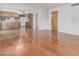 Open concept living room adjacent to the kitchen, featuring hardwood floors and bright lighting at 1704 E Hackamore St, Mesa, AZ 85203